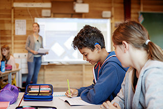 Roger SoundField system showing a classroom speaker on a stand and a wireless microphone used to improve speech clarity in group settings.