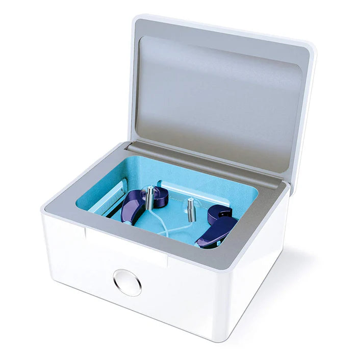 White and gray case with blue interior containing purple ear devices on a white background