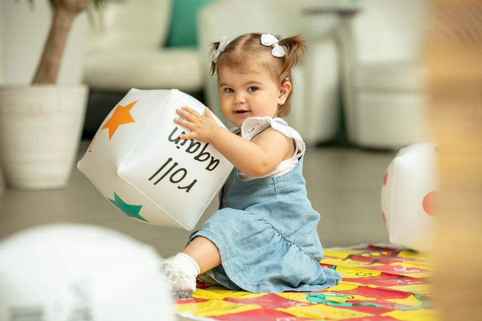 Chime Newly Diagnosed Weekend for Families of Children with a Hearing Loss Friday, October 6th, to Sunday, October 8th, 2023 as a Child with a cochlear implants enjoys playing with uninflatable cube