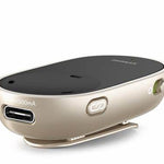 A compact, beige and black assistive listening Phonak PartnerMic device featuring a clip on the bottom for attaching to clothing. The front side has a USB port labeled '500mA' for charging, and a small button marked with a Bluetooth symbol. The device also has an on/off switch on the side and a sleek, curved design.