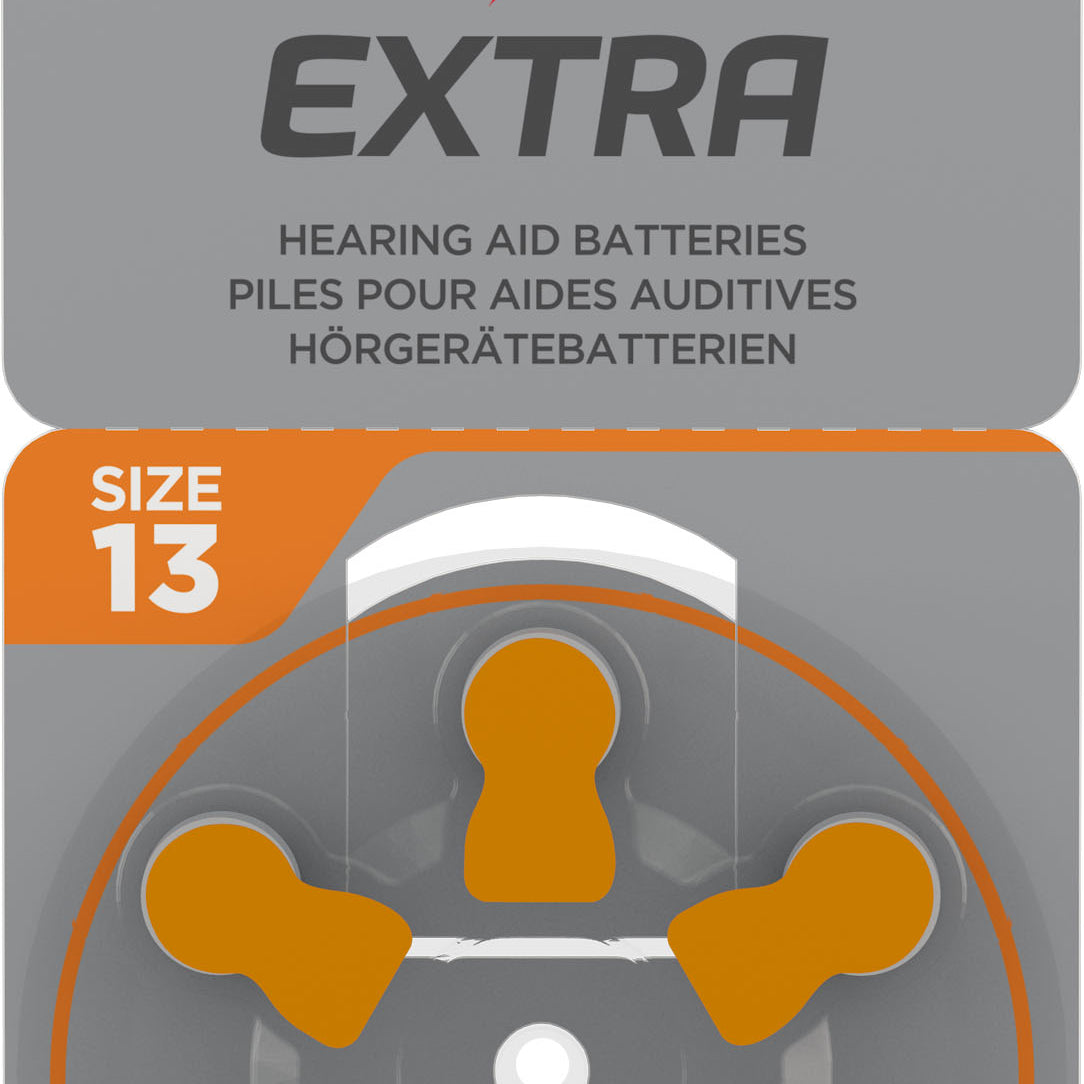 Packaging of Rayovac Extra hearing aid batteries, Size 13, 6-pack. The front of the package is gray with orange accents, featuring the Rayovac Extra logo with a red and black lightning bolt. A wheel of six batteries, marked with orange tabs, is visible through a transparent section.