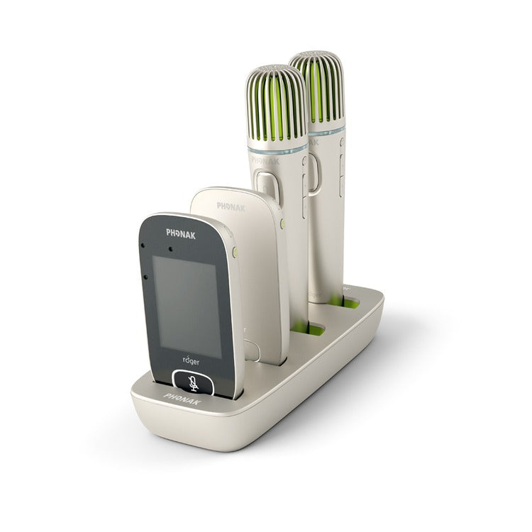 Roger Charging Rack with four Phonak Roger devices inserted two Pass-around Microphones and two Touchscreen Mics charging simultaneously in a compact, organised dock for classroom use.