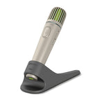 Phonak Roger Pass-around Microphone placed in its black charging stand, designed for classroom use with Roger SoundField systems to support inclusive audio and student participation.