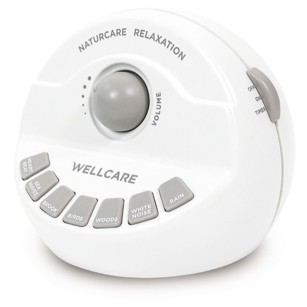 Close-up of white tinnitus sound relaxer showing volume control and buttons for heartbeat, sea waves, brook, birds, woods, white noise, and rain. Simple tabletop sound therapy device with on/off timer switch.
