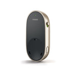 The image depicts a Phonak PartnerMic, a wireless microphone designed to assist people with hearing aids by improving speech understanding in challenging listening environments. The device is oval-shaped, with a sleek black front and gold-colored sides. It has a small green light indicator at the top for power status, a switch on the side to turn it on or off, and a button at the bottom for pairing the microphone to Phonak Hearing Aids.